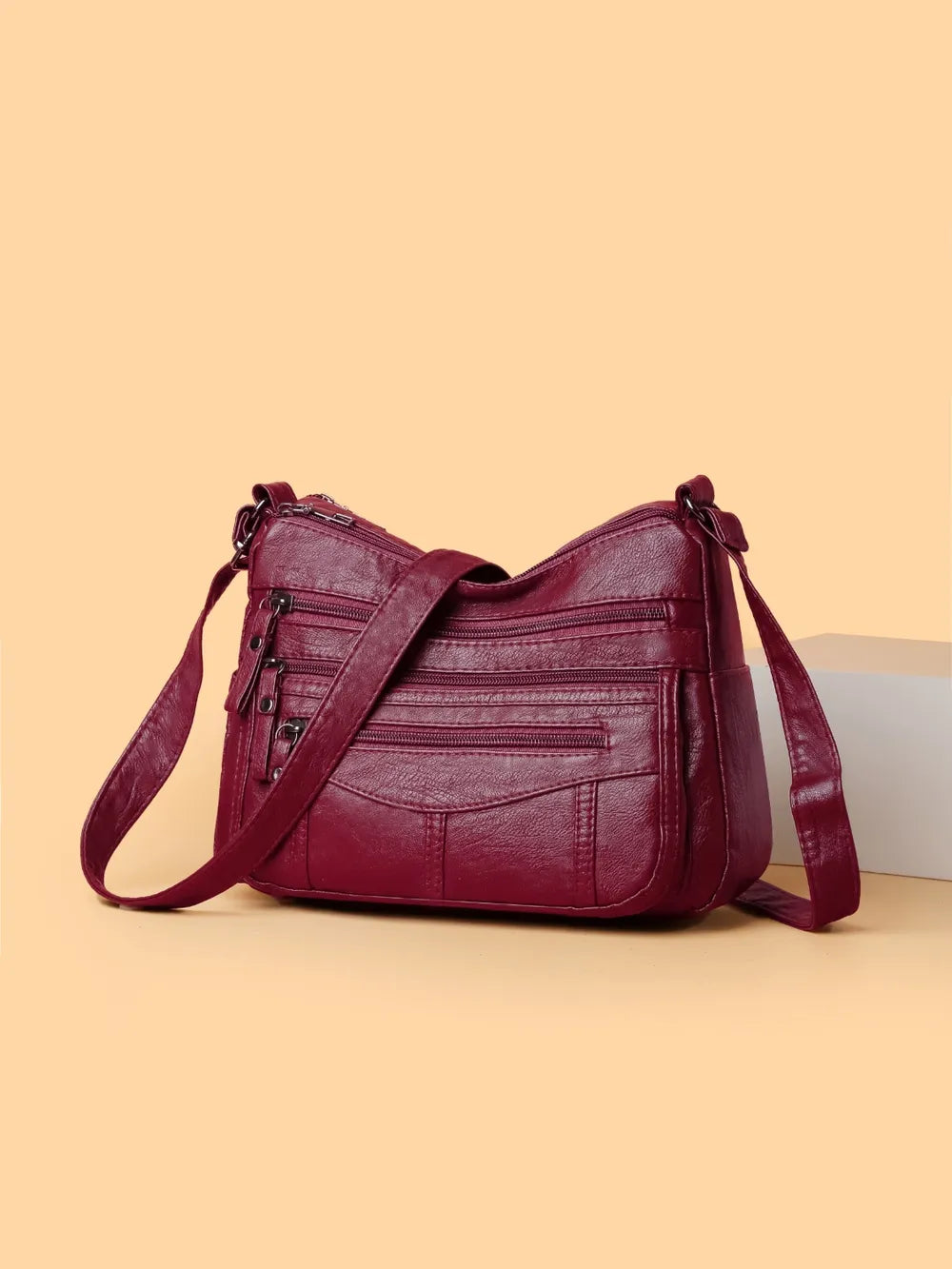 Bolso bandolera con varios compartimentos de 26 × 18 × 9 cm